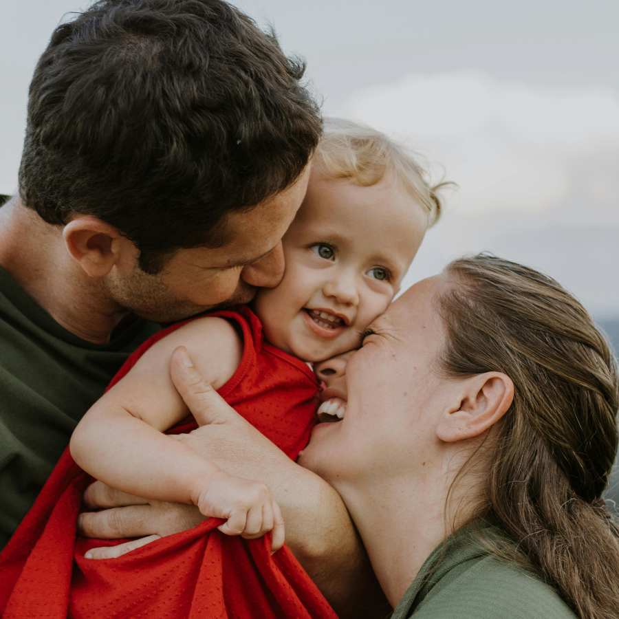 man and child hugging blond toddler