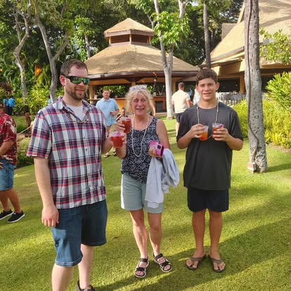 grandma with uncle and grandson at a luau in hawaii