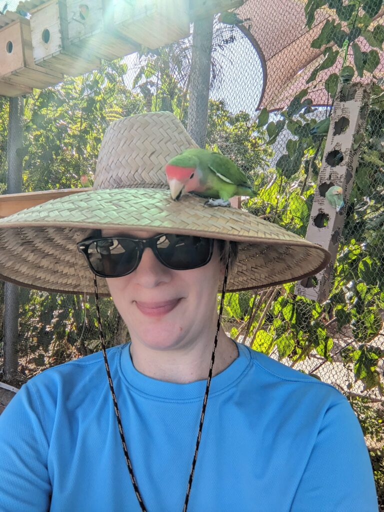 woman with a bird on her hat in hawaii at sea life park 
